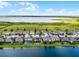 Scenic aerial view of waterside homes boasting green lawns and sparkling lake views at 5029 Hartwell Ct, St Cloud, FL 34771