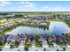 Aerial view of community homes next to the water with solar panels at 5029 Hartwell Ct, St Cloud, FL 34771