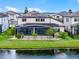 Scenic view of the back of the property, highlighting its lakefront location and screened-in lanai at 5029 Hartwell Ct, St Cloud, FL 34771