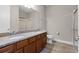 Bathroom with double vanity, granite counters, and a shower with sliding glass doors at 5029 Hartwell Ct, St Cloud, FL 34771