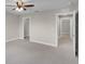 Spacious bedroom with neutral colors, a ceiling fan, and access to closet and hallway at 5029 Hartwell Ct, St Cloud, FL 34771