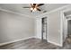 Bedroom features wood-look tile flooring, ceiling fan, and closet with shelving at 5029 Hartwell Ct, St Cloud, FL 34771