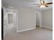 Spacious bedroom with neutral colors, a ceiling fan, and access to closet and hallway at 5029 Hartwell Ct, St Cloud, FL 34771