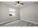 Bedroom with window, wood-look tile flooring, and light neutral walls at 5029 Hartwell Ct, St Cloud, FL 34771
