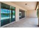 Covered patio featuring tile flooring and sliding glass doors with a view of the lake at 5029 Hartwell Ct, St Cloud, FL 34771