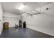 View of an empty garage showing epoxy floors and storage racks, offering ample space for parking and storage at 5029 Hartwell Ct, St Cloud, FL 34771