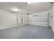 Spacious two-car garage with epoxy flooring, Tesla Powerwall and ample storage space at 5029 Hartwell Ct, St Cloud, FL 34771