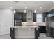 Modern kitchen featuring an island with pendant lights, stainless steel appliances, and sleek dark cabinetry at 5029 Hartwell Ct, St Cloud, FL 34771