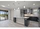 Modern kitchen island with stainless steel appliances, sleek dark cabinetry and pendant lights at 5029 Hartwell Ct, St Cloud, FL 34771