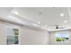 Bright living room with tray ceiling, recessed lighting, and large windows at 5029 Hartwell Ct, St Cloud, FL 34771