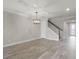 Open concept with tile floors, tray ceiling detail and staircase leading to upper level in a neutral color palette at 5029 Hartwell Ct, St Cloud, FL 34771