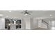 Open floor plan with modern kitchen and stainless appliances viewed from the living room at 5029 Hartwell Ct, St Cloud, FL 34771