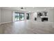 Open concept living room with tile floors and sliding glass doors to the outside with views into the kitchen at 5029 Hartwell Ct, St Cloud, FL 34771