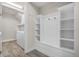 Mud room features built-in shelving and coat racks near washer and dryer at 5029 Hartwell Ct, St Cloud, FL 34771