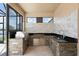 Covered outdoor kitchen with built-in grill, stone accents, and a serene view at 5029 Hartwell Ct, St Cloud, FL 34771