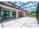 Lakefront backyard featuring a screened patio, beautiful landscaping, and serene water views at 5029 Hartwell Ct, St Cloud, FL 34771