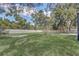 Large grassy backyard with privacy fence and scattered trees, a perfect canvas for outdoor activities and enjoyment at 5882 Marlberry Dr, Orlando, FL 32819
