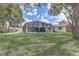 Manicured backyard featuring a screened-in pool enclosure, offering a blend of privacy and outdoor enjoyment at 5882 Marlberry Dr, Orlando, FL 32819