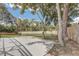 View of the backyard with mature trees and a concrete patio perfect for entertaining at 5882 Marlberry Dr, Orlando, FL 32819