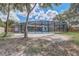 Expansive backyard showcases a screened pool enclosure, inviting outdoor fun in a private and tranquil setting at 5882 Marlberry Dr, Orlando, FL 32819