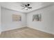 Well-lit bedroom showcasing two windows and a neutral color palette at 5882 Marlberry Dr, Orlando, FL 32819