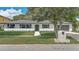 Charming single-story home with a white brick facade, dark shutters, and a well-kept lawn at 5882 Marlberry Dr, Orlando, FL 32819