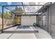 Relax in a screened-in backyard hot tub with tile accents, easily accessible from the home's entrance at 5882 Marlberry Dr, Orlando, FL 32819