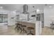 Modern kitchen boasts an island with seating, stainless steel appliances, and marble countertops at 5882 Marlberry Dr, Orlando, FL 32819