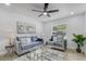 Cozy living room with stylish furniture, a ceiling fan, and a large window offering natural light at 5882 Marlberry Dr, Orlando, FL 32819