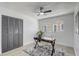 Home office with gray walls, a modern desk, and a large window providing natural light at 5882 Marlberry Dr, Orlando, FL 32819