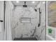 Elegant shower featuring marble tiling, black hardware, and a built-in niche at 5882 Marlberry Dr, Orlando, FL 32819