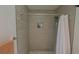 Close-up of an updated shower featuring a tile surround and a shower caddy with bath products at 641 Maple Oak Cir # 101, Altamonte Springs, FL 32701