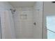 Shower with white tile walls, a decorative accent stripe, and a shower curtain at 641 Maple Oak Cir # 101, Altamonte Springs, FL 32701
