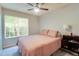 Bright bedroom with a ceiling fan, a large window with blinds, and a comfortable bed at 641 Maple Oak Cir # 101, Altamonte Springs, FL 32701
