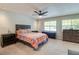 Bedroom with two bright windows, a ceiling fan and carpet, featuring two dressers and a nightstand at 641 Maple Oak Cir # 101, Altamonte Springs, FL 32701