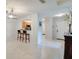 Dining area with bar seating overlooking the kitchen and a view of the entryway with a white front door at 641 Maple Oak Cir # 101, Altamonte Springs, FL 32701