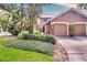Inviting two-story home with a neutral color palette, lush landscaping, and attached garage at 641 Maple Oak Cir # 101, Altamonte Springs, FL 32701