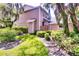 Exterior view of home with bushes, trees, and walkway at 641 Maple Oak Cir # 101, Altamonte Springs, FL 32701