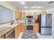 Well-equipped kitchen featuring stainless steel appliances and wood cabinets at 641 Maple Oak Cir # 101, Altamonte Springs, FL 32701