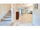 View of carpeted stairs leading to an open-concept living room with tiled floors and large windows at 641 Maple Oak Cir # 101, Altamonte Springs, FL 32701