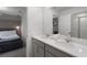 Bright bathroom featuring a double sink vanity with gray cabinets, white countertops and a mirror reflecting the shower at 8913 Coconut Breeze Dr, Kissimmee, FL 34747