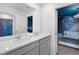 A bathroom with a space theme boasts a double sink vanity and a connected bedroom at 8913 Coconut Breeze Dr, Kissimmee, FL 34747
