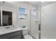 A clean bathroom with a window features a shower, sink and modern fixtures at 8913 Coconut Breeze Dr, Kissimmee, FL 34747