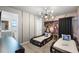 A unique bedroom with a Transformer theme features car beds and a cartoon accent wall at 8913 Coconut Breeze Dr, Kissimmee, FL 34747