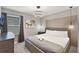 Comfortable bedroom showcasing a neatly made bed, modern lighting, neutral walls and a decorative headboard feature at 8913 Coconut Breeze Dr, Kissimmee, FL 34747