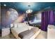 A bedroom with a space theme boasts a solar system wall and a comfy bed at 8913 Coconut Breeze Dr, Kissimmee, FL 34747