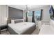A primary bedroom features a stylish chandelier, large windows and a bassinet at 8913 Coconut Breeze Dr, Kissimmee, FL 34747