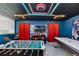 Game room featuring foosball table, air hockey, blue walls, and neon ceiling lights for entertainment at 8913 Coconut Breeze Dr, Kissimmee, FL 34747