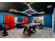 Fun game room featuring foosball table, air hockey, blue walls, and neon ceiling lights for entertainment at 8913 Coconut Breeze Dr, Kissimmee, FL 34747
