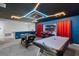 Fun game room featuring foosball table, air hockey, blue walls, and neon ceiling lights for entertainment at 8913 Coconut Breeze Dr, Kissimmee, FL 34747